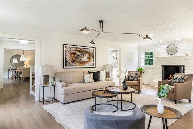 2015 Clipper Straits, Snellville, GA 30078 - living room with wood finished floors, a brick fireplace, and a textured ceiling