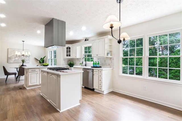 2015 Clipper Straits, Snellville, GA 30078 - kitchen with appliances with stainless steel finishes, a center island, light countertops, open shelves, and a textured ceiling