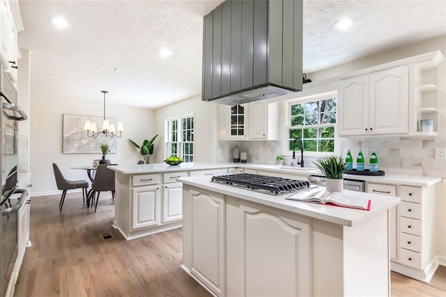 2015 Clipper Straits, Snellville, GA 30078 - kitchen with open shelves, a textured ceiling, stainless steel gas stovetop, plenty of natural light, and tasteful backsplash