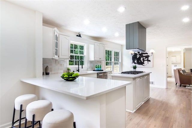 2015 Clipper Straits, Snellville, GA 30078 - kitchen with stainless steel appliances, a kitchen breakfast bar, recessed lighting, a textured ceiling, and light wood-style flooring