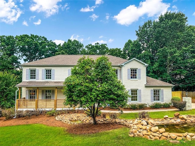 2015 Clipper Straits, Snellville, GA 30078 - view of front of house featuring covered porch, brick siding, and roof with shingles