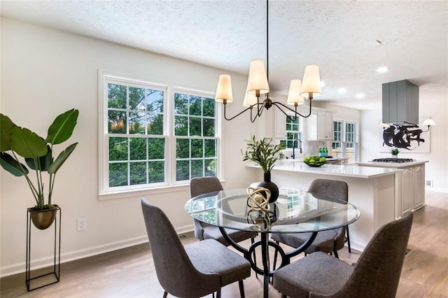 2015 Clipper Straits, Snellville, GA 30078 - dining room with a textured ceiling, healthy amount of natural light, a chandelier, light wood-style floors, and recessed lighting
