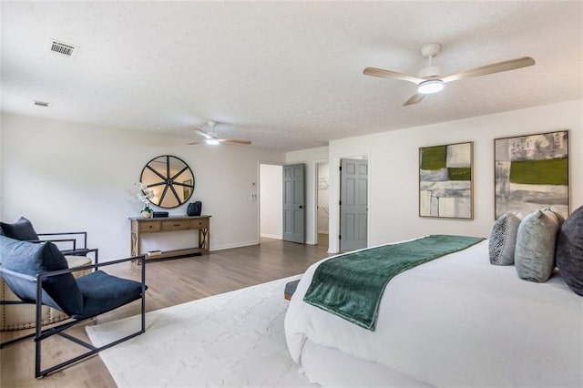 2015 Clipper Straits, Snellville, GA 30078 - bedroom featuring a textured ceiling, wood finished floors, and a ceiling fan
