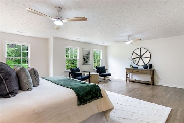 2015 Clipper Straits, Snellville, GA 30078 - bedroom featuring wood finished floors, multiple windows, a textured ceiling, and a ceiling fan