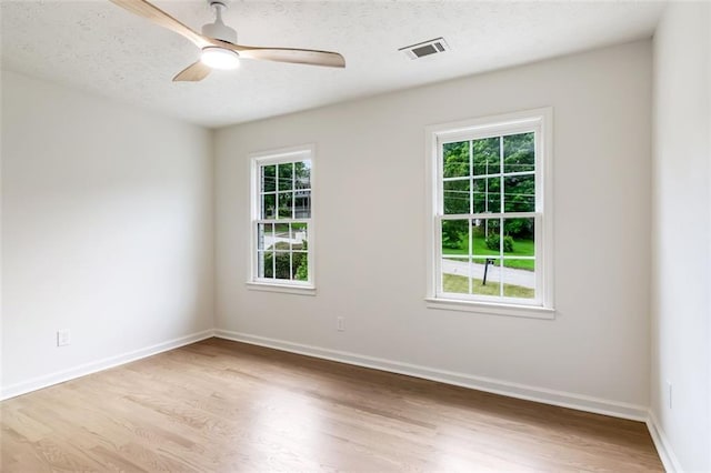 2015 Clipper Straits, Snellville, GA 30078 - empty room featuring wood finished floors, plenty of natural light, a ceiling fan, and a textured ceiling