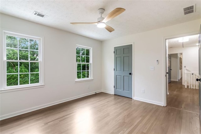 2015 Clipper Straits, Snellville, GA 30078 - unfurnished bedroom featuring wood finished floors, a textured ceiling, and ceiling fan