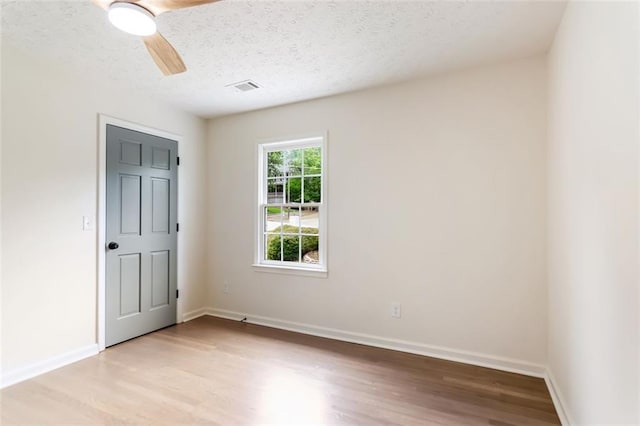 2015 Clipper Straits, Snellville, GA 30078 - unfurnished bedroom with light wood finished floors, a textured ceiling, and ceiling fan