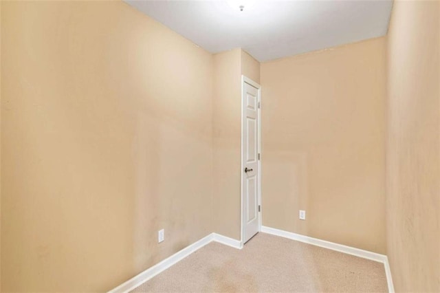 empty room featuring baseboards and carpet floors