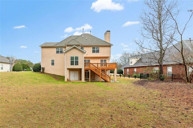 back of property featuring stucco siding, a lawn, stairs, a wooden deck, and a chimney