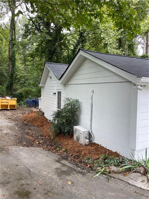 view of side of home with ac unit