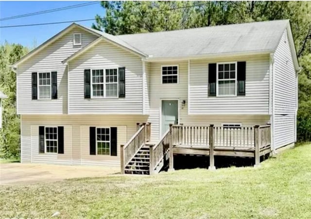 view of front facade with a patio area, a deck, and a front lawn