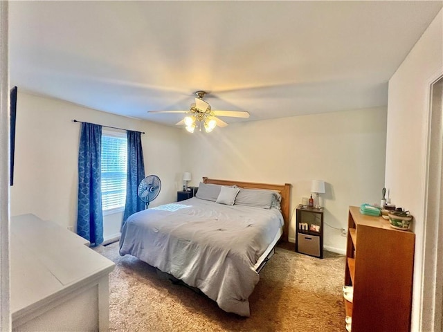 bedroom with baseboards, a ceiling fan, and light colored carpet