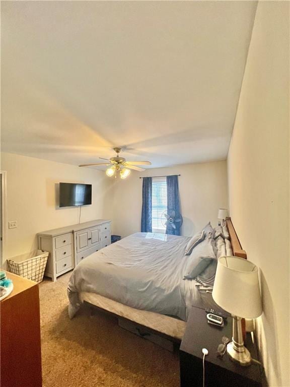 bedroom with a ceiling fan and carpet flooring