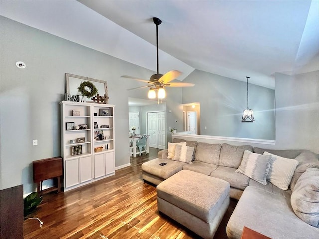 living room featuring vaulted ceiling, wood finished floors, and a ceiling fan