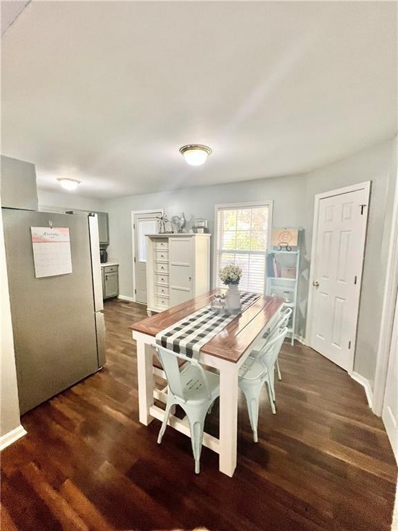 dining room with dark wood-style flooring and baseboards