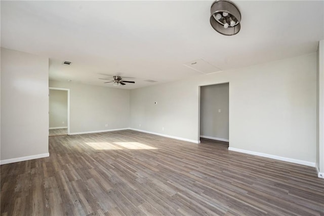 unfurnished room with visible vents, wood finished floors, baseboards, and ceiling fan