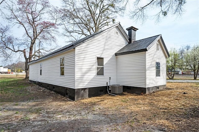 view of property exterior with crawl space, central AC unit, and a chimney