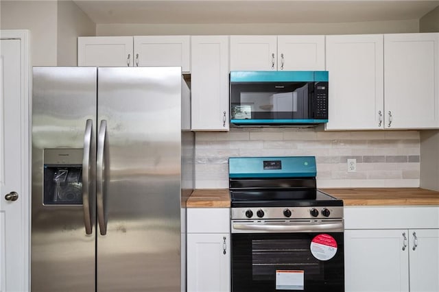 kitchen with butcher block countertops, white cabinetry, and stainless steel appliances