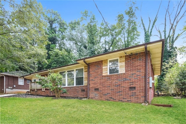 view of side of home featuring a lawn