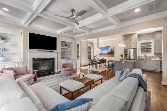 540 Woodall Ave NE, Atlanta, GA 30306 - living area featuring a glass covered fireplace, visible vents, built in features, ceiling fan with notable chandelier, and wood finished floors