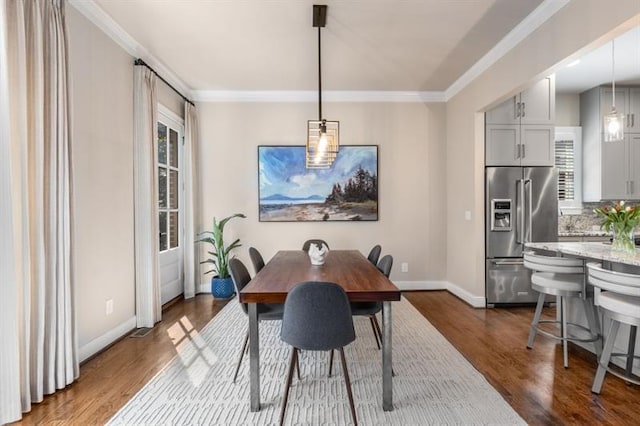 540 Woodall Ave NE, Atlanta, GA 30306 - dining area featuring baseboards, a healthy amount of sunlight, ornamental molding, and dark wood finished floors