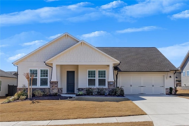 craftsman-style house with driveway, stone siding, an attached garage, and a shingled roof