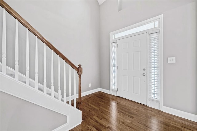 entrance foyer featuring stairway, wood finished floors, and baseboards