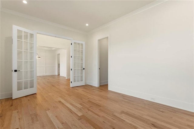 empty room with baseboards, ornamental molding, french doors, light wood-type flooring, and recessed lighting