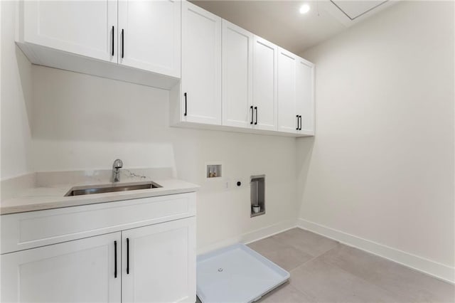 washroom featuring hookup for a washing machine, a sink, baseboards, cabinet space, and electric dryer hookup