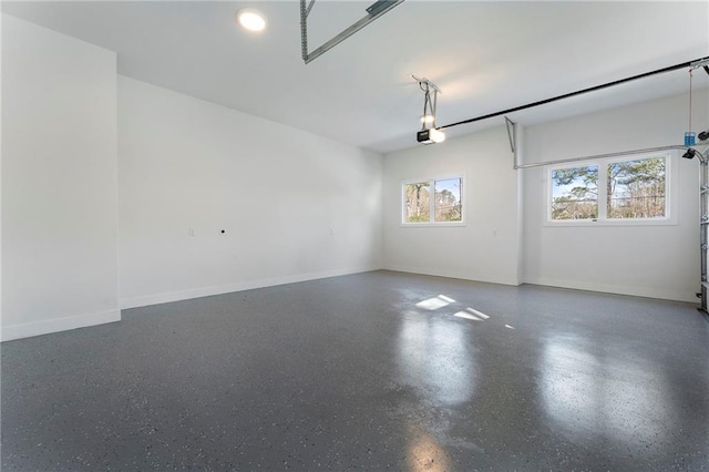 garage featuring baseboards and a garage door opener