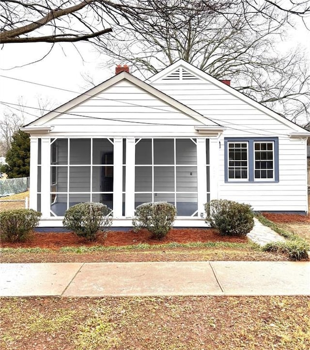 view of front of home featuring a sunroom