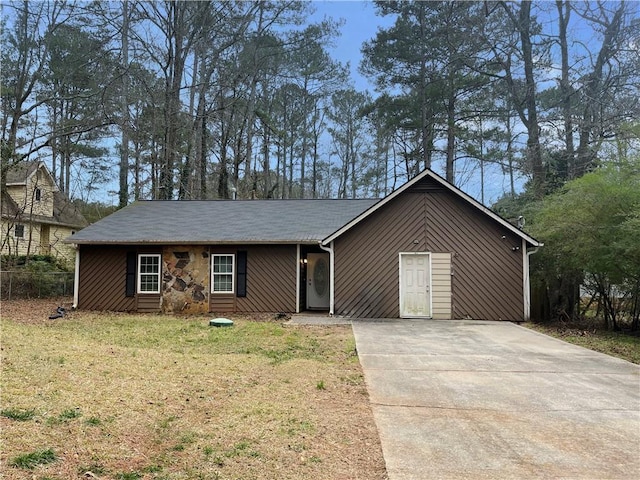 ranch-style home with a front lawn