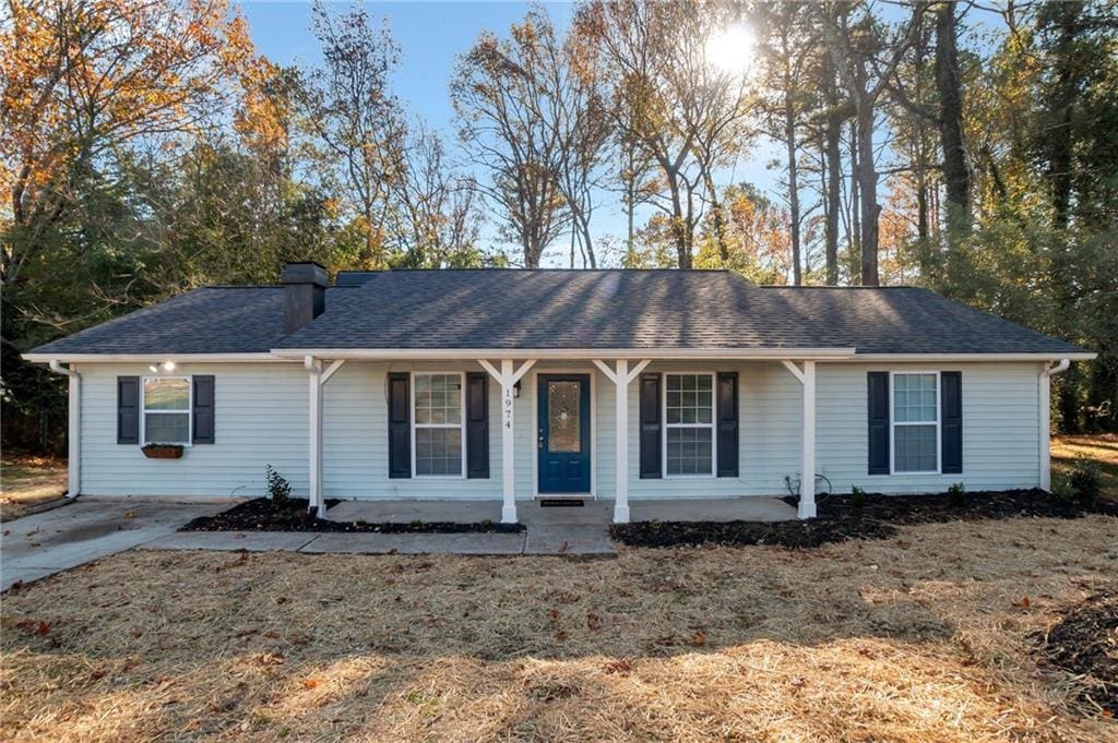 ranch-style home with a porch and a front yard