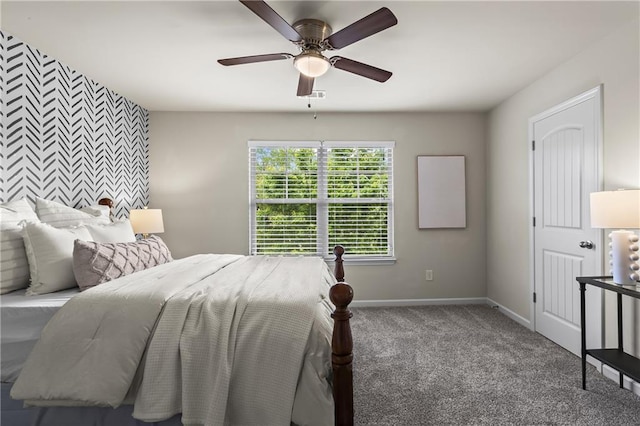 bedroom with baseboards, carpet, a ceiling fan, and an accent wall