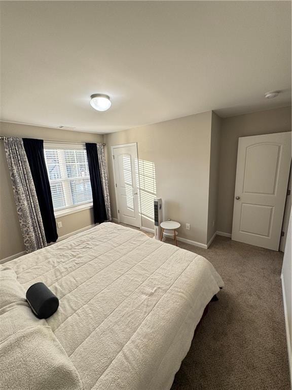 carpeted bedroom with baseboards