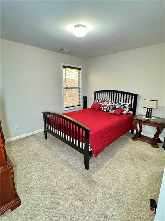 bedroom with carpet flooring, visible vents, and baseboards