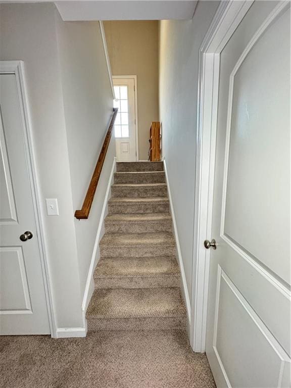 stairs with carpet and baseboards