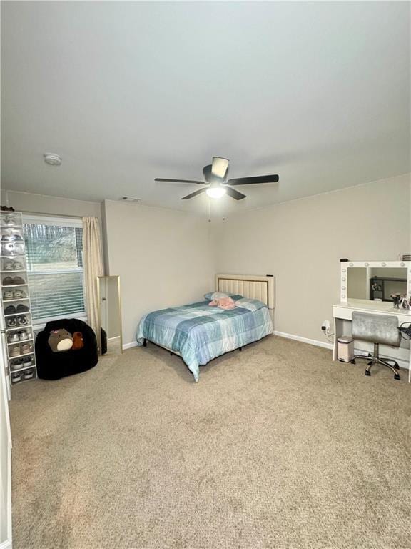 bedroom with carpet flooring, a ceiling fan, and baseboards