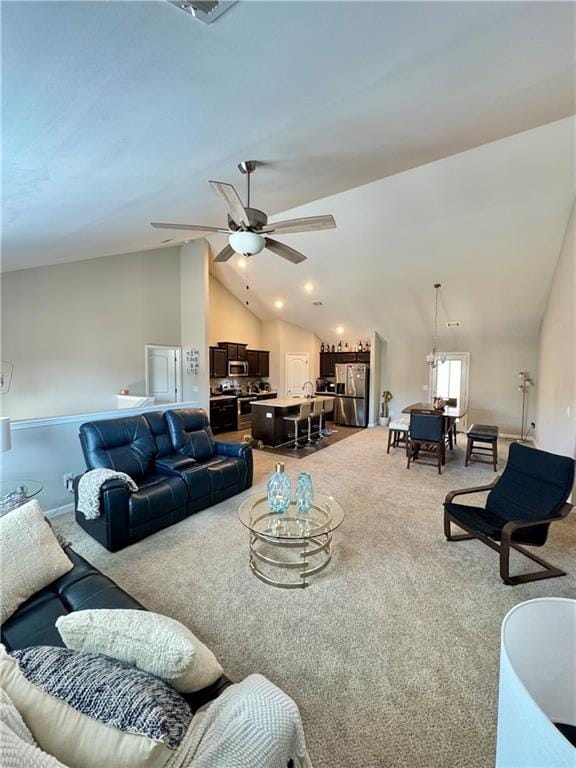 living area with vaulted ceiling, ceiling fan, and light colored carpet