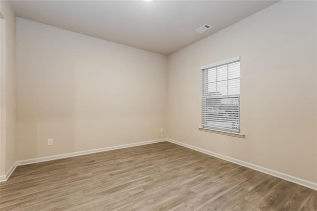 spare room featuring light hardwood / wood-style floors