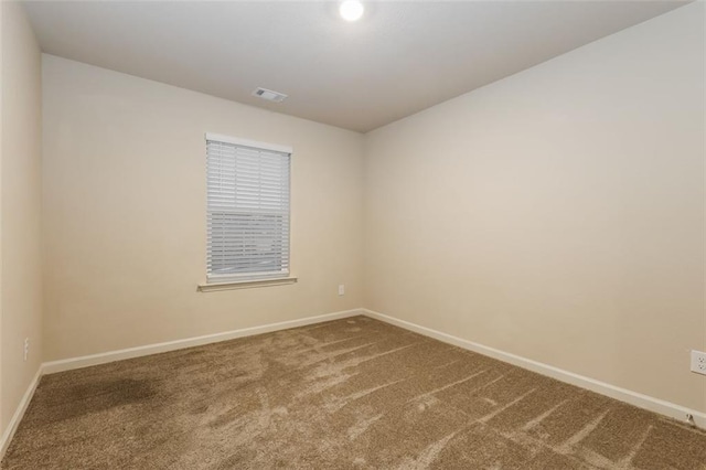 spare room featuring carpet floors