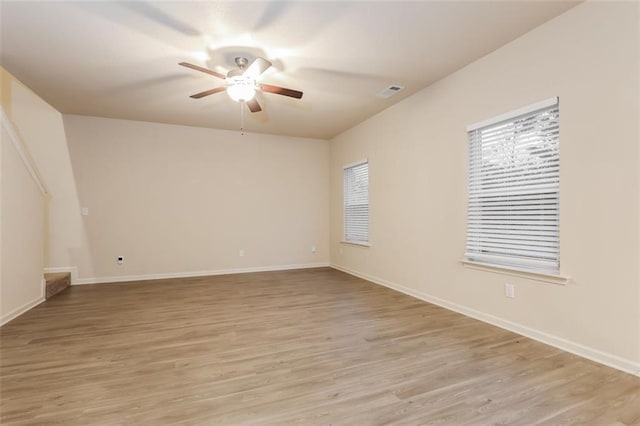 empty room featuring ceiling fan and light wood-type flooring