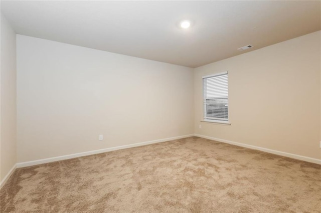 empty room with light colored carpet