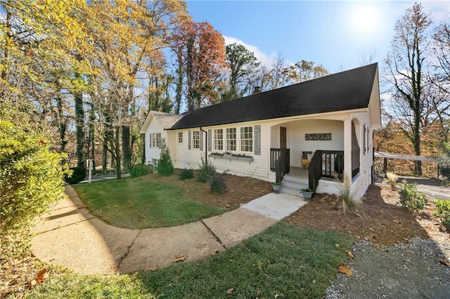 view of front of house with covered porch and a front yard