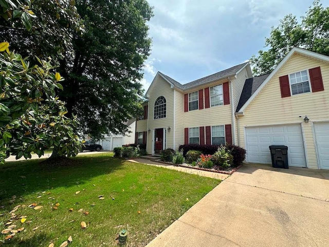 view of front of home featuring driveway, a front yard, and a garage