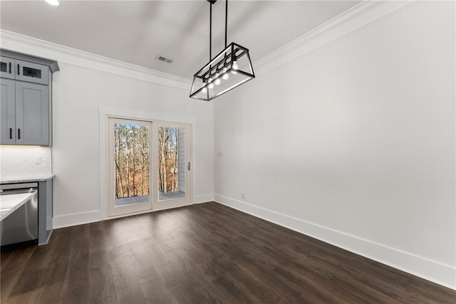 unfurnished dining area with ornamental molding, visible vents, dark wood finished floors, and baseboards