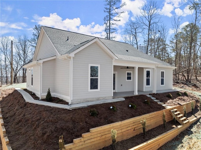 view of front facade featuring covered porch and roof with shingles