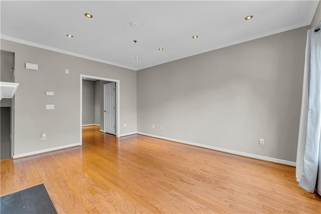 unfurnished living room featuring crown molding and light hardwood / wood-style flooring