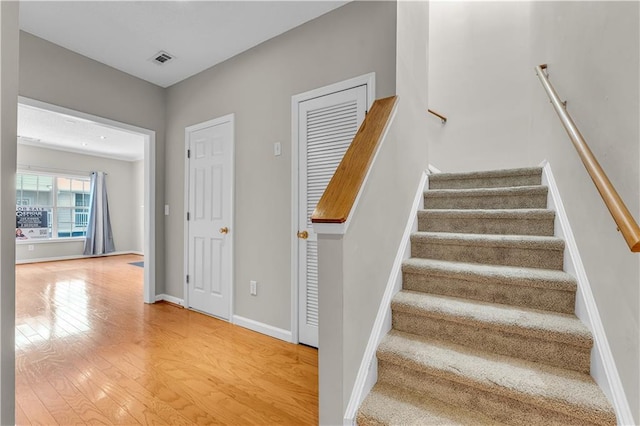 stairs with hardwood / wood-style floors