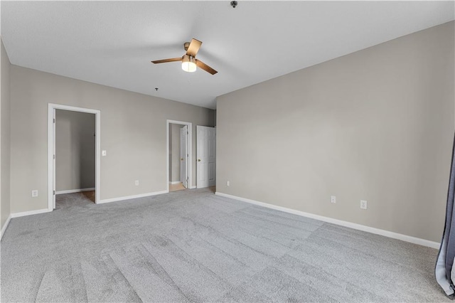 empty room with ceiling fan and light colored carpet